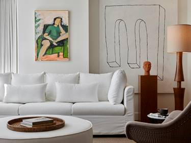 Plush white sofa and artwork in Lyle Suite.