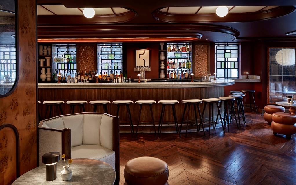 Barstools and soft lighting in the bar at Lyle's in DC.