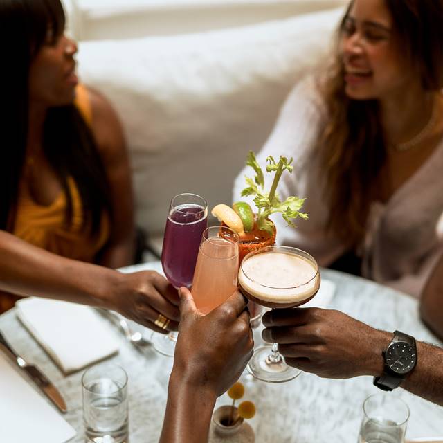 People enjoying cocktails at Lyle's Restaurant and Bar
