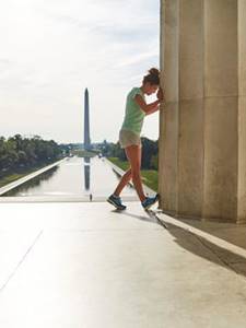 Woman stretching in front of the Washington Monument