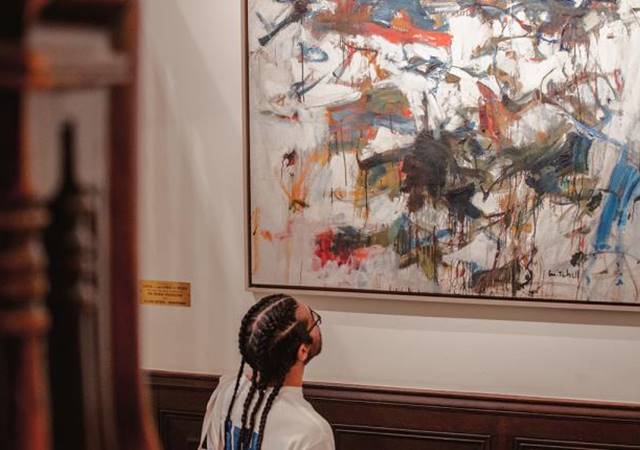 Person looking at painting 