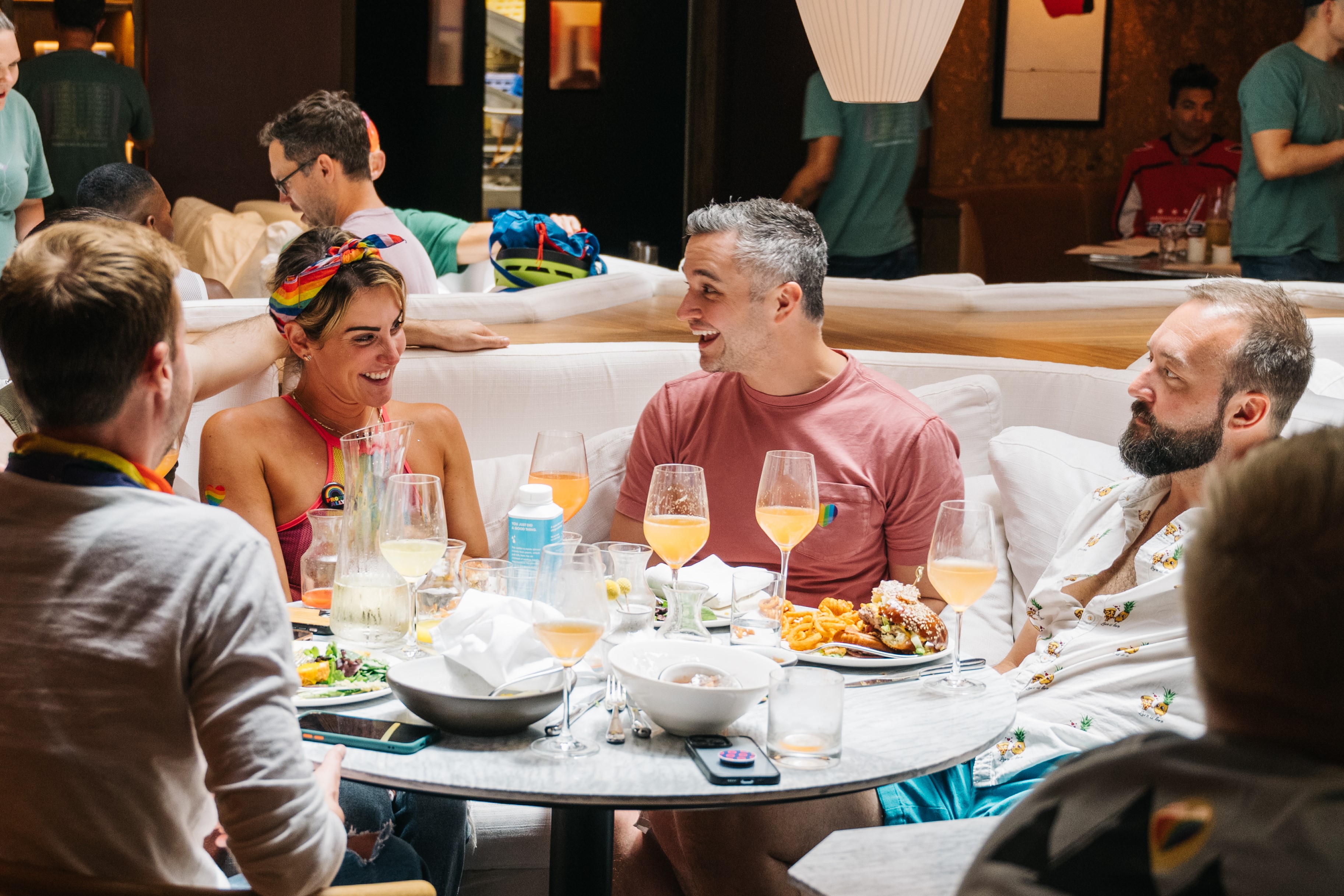 A lively restaurant filled with guests dining, laughing, and enjoying beverages at Drag Brunch in DC.