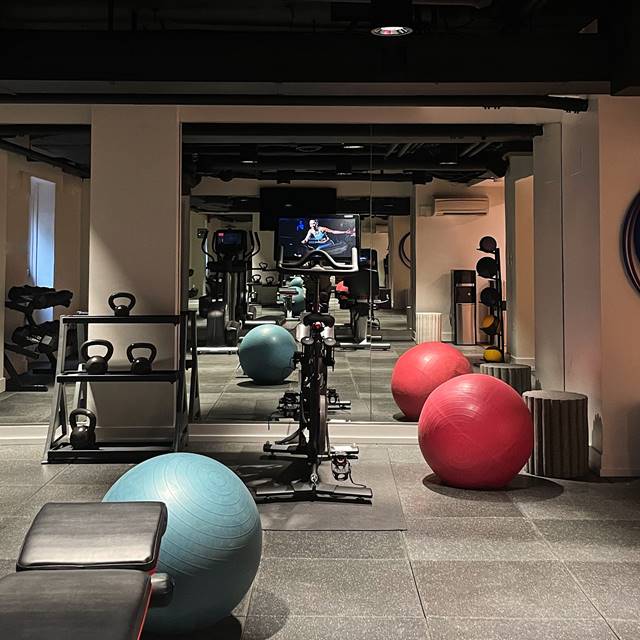 Lyle gym showing free weights and peloton bike