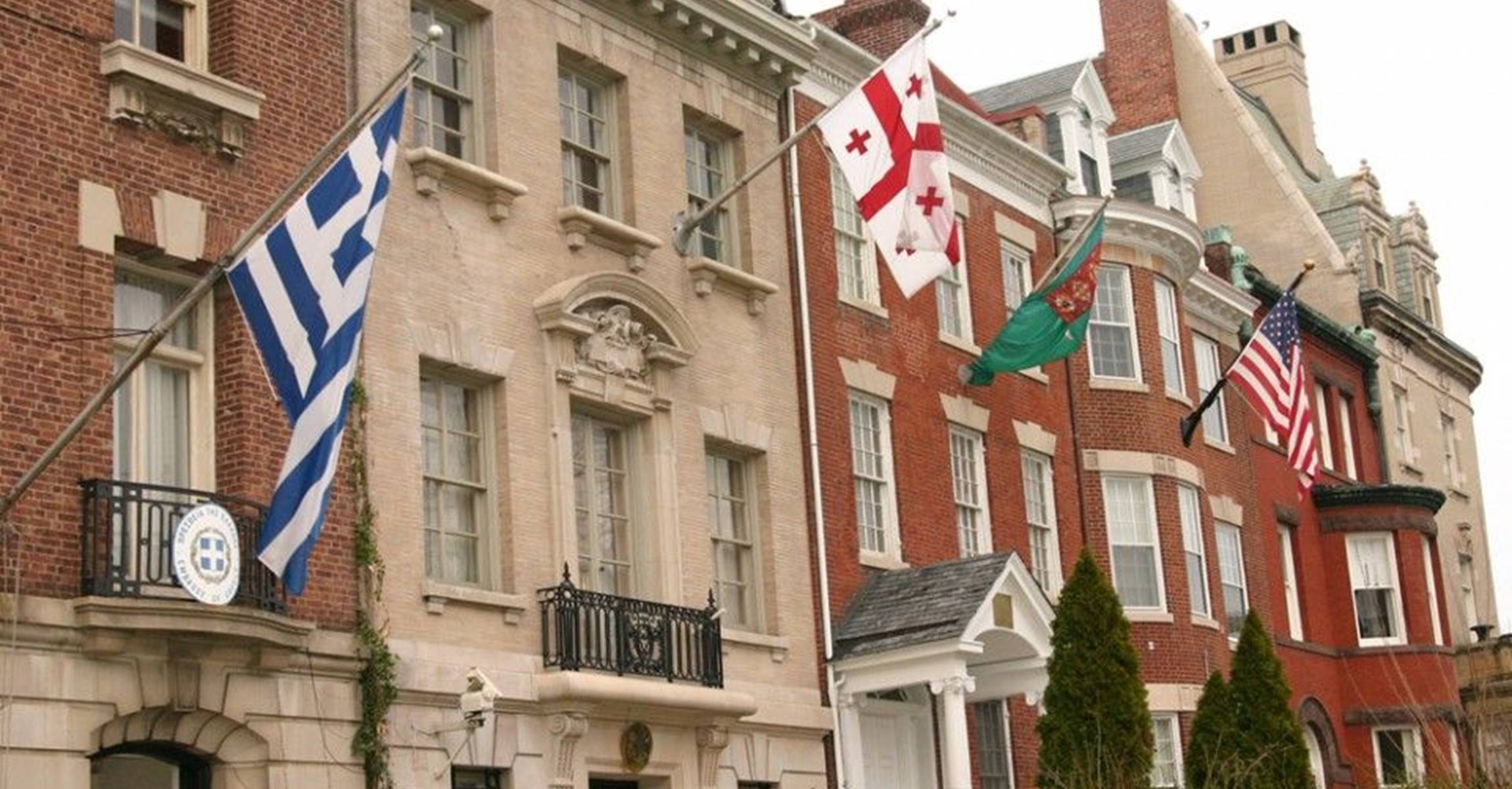 A historic building with flags flying from its facade