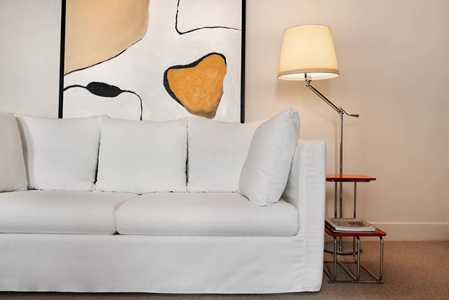 White sofa with a lamp shining over it at Lyle DC.