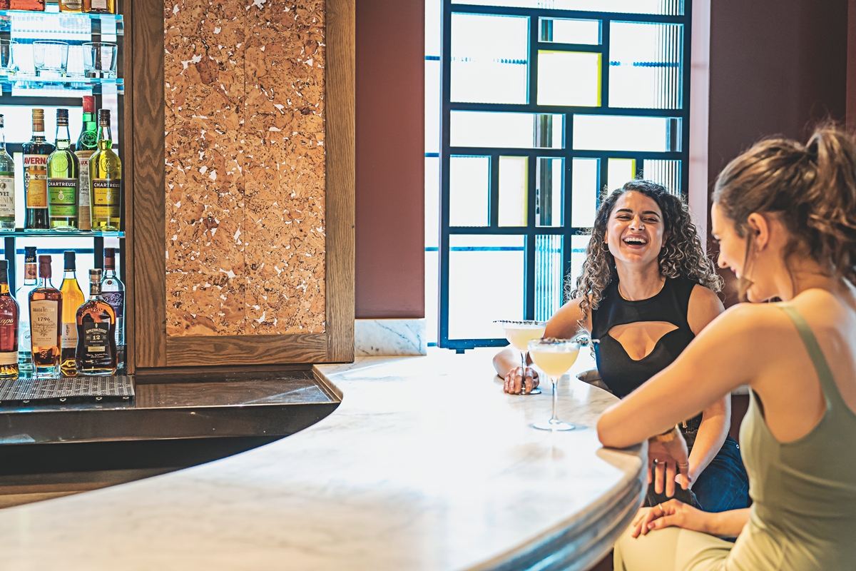 People enjoy a cocktail at Lyle's Restaurant and Bar