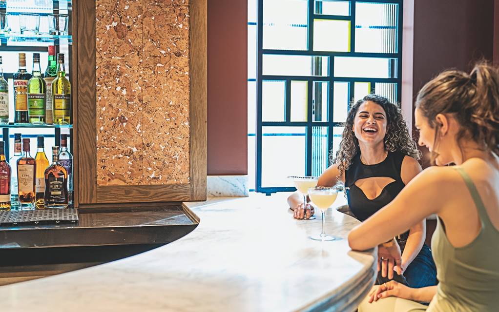 People enjoy a cocktail at Lyle's Restaurant and Bar